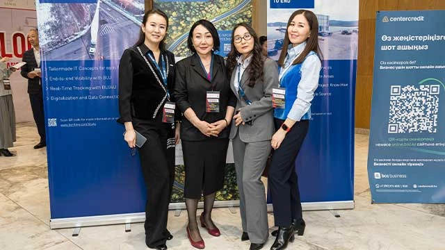 Four woman in suits standing in group facing the camera